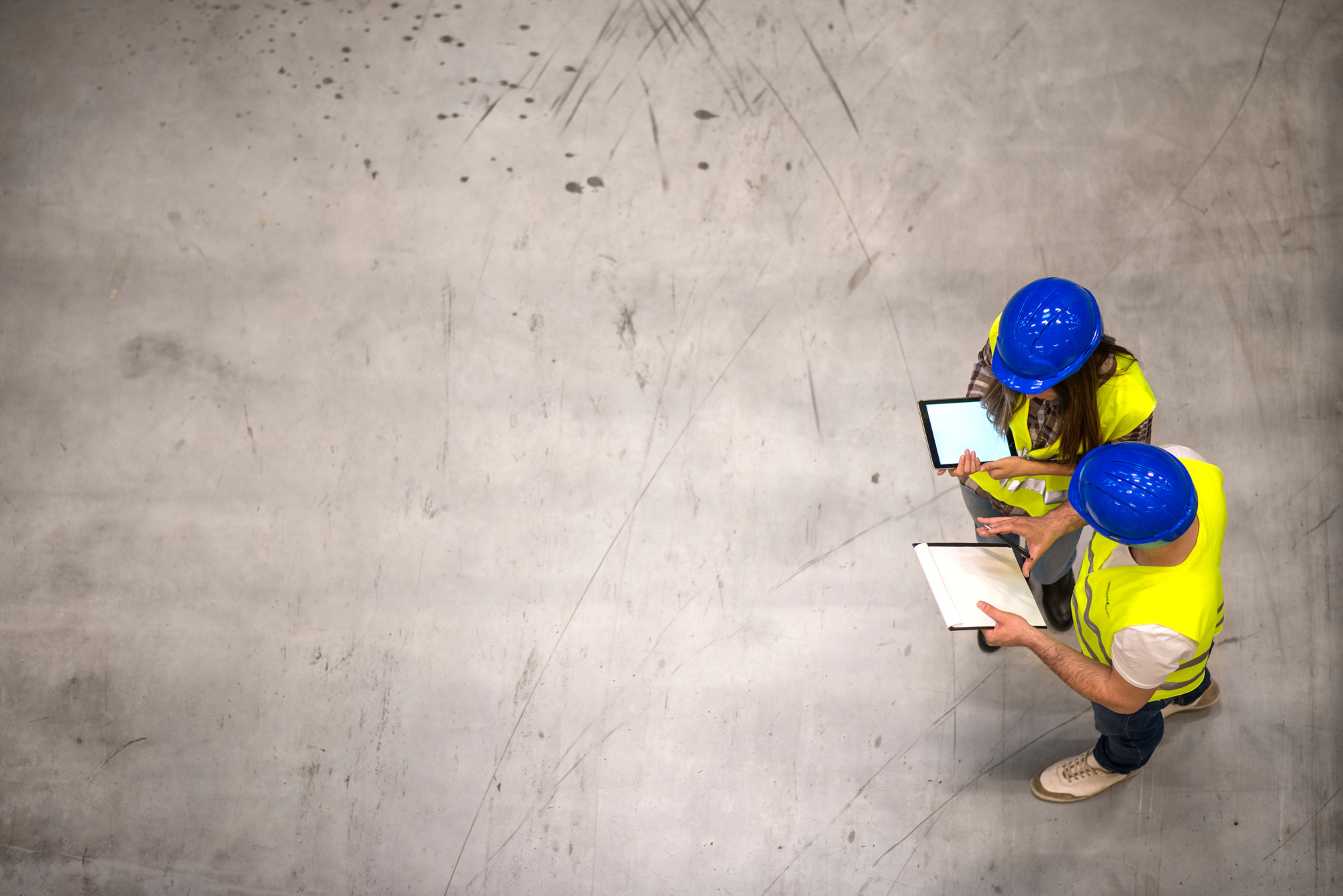 top-view-two-industrial-workers-wearing-hardhats